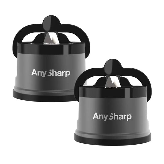 AnySharp Pro metal knife sharpener 2 pack in brushed alloy red and silver finish suctioned firmly onto a dark granite kitchen countertop next to a chef knife.