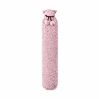 A 72cm Aroma Home long hot water bottle wrapped in a plush grey faux fur cover resting draped across a beige sofa cushion.