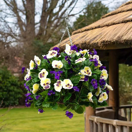 Realistic artificial flower hanging basket with vibrant pink and white blooms hanging from a porch.