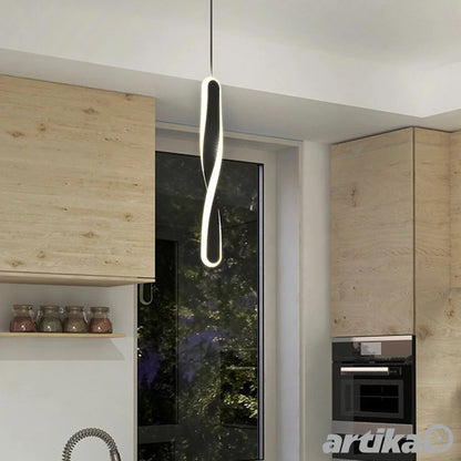 Black Artika Finley LED pendant light with modern minimalist design, suspended over kitchen island for ambient lighting