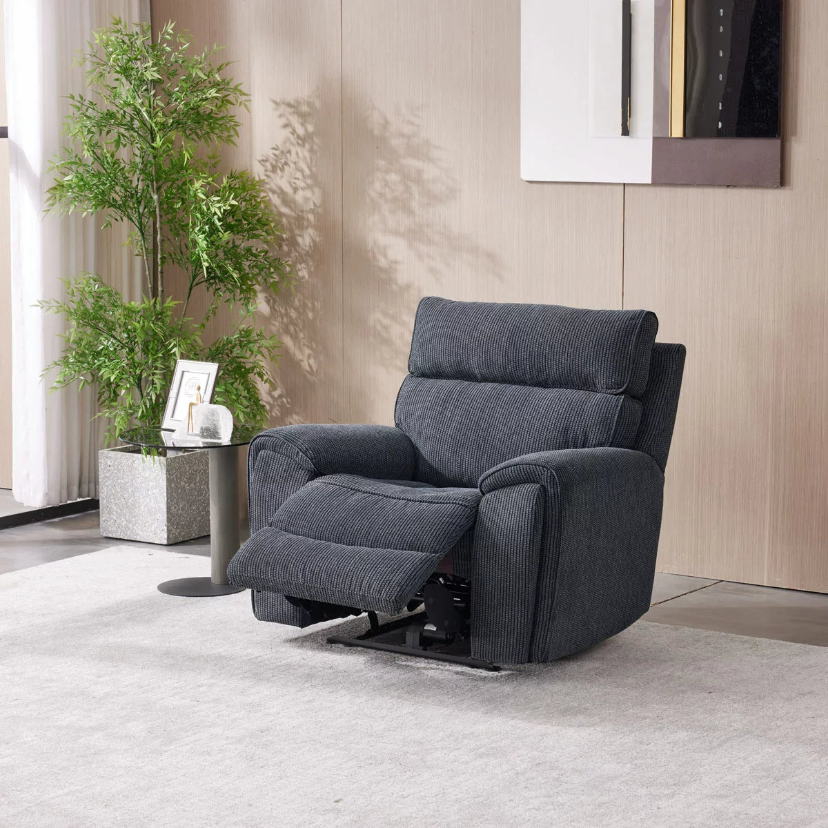 Three-quarter view of the Atlanta grey cord fabric power recliner armchair in a bright living room setting, showcasing its striped textured fabric and sleek side