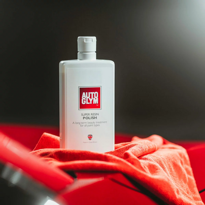Autoglym Essential Bodywork and Wheels Collection Kit featuring five 500ml detailing bottles neatly arrayed next to a glossy car bumper.