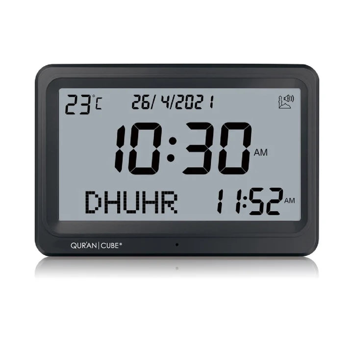 Front view of the black digital Adhan clock resting on its table stand, displaying the time, current room temperature, and calculated prayer schedules in crisp digital numbers.