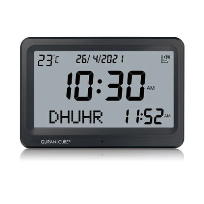 Front view of the black digital Adhan clock resting on its table stand, displaying the time, current room temperature, and calculated prayer schedules in crisp digital numbers.