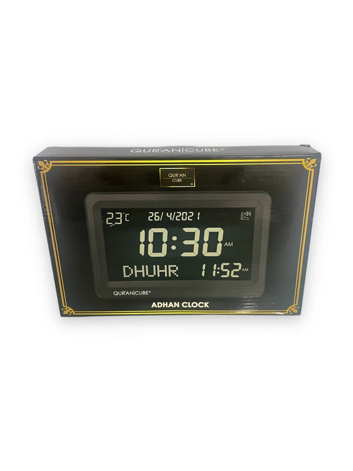 Front view of the black digital Adhan clock resting on its table stand, displaying the time, current room temperature, and calculated prayer schedules in crisp digital numbers.