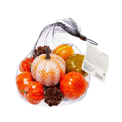Textured orange, green, and mini artificial pumpkins paired with fabric autumn leaves and pine cones arranged neatly on a wooden table setting.