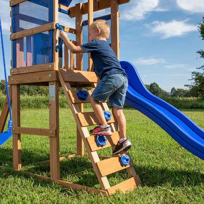 Backyard Discovery Aurora brown cedar wood swingset playcentre with canopy roof, rock wall ladder, wave slide, chalkboard, and garden swing area for children.