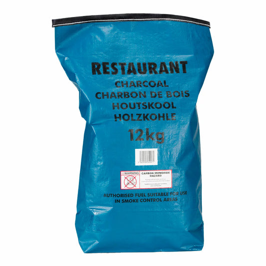 A 12kg bag of Bar-Be-Quick Restaurant Charcoal placed next to a high-end stainless steel professional grill, highlighting the clean, dense texture of the premium charcoal pieces.