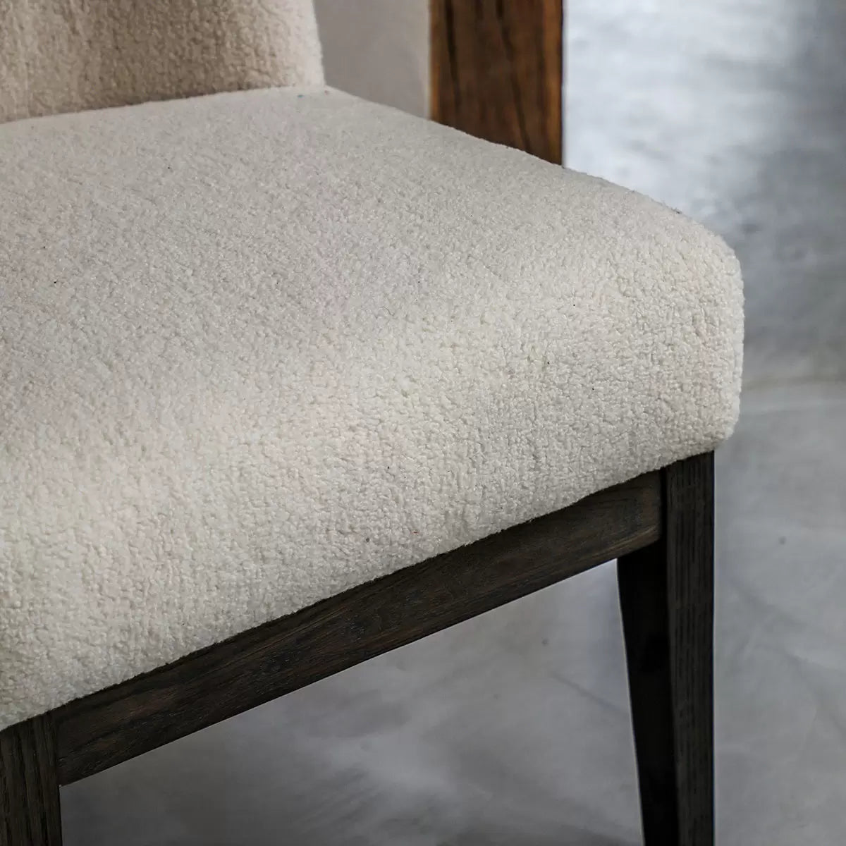 Front view of the Gallery Bardfield cream teddy fabric chair showcasing its textured boucle upholstery and light solid oak legs in a brightly lit room.