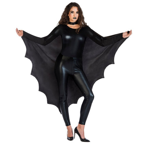 Adult wearing a jet black bat wing cape with scalloped edges fully extended against a dark backdrop.