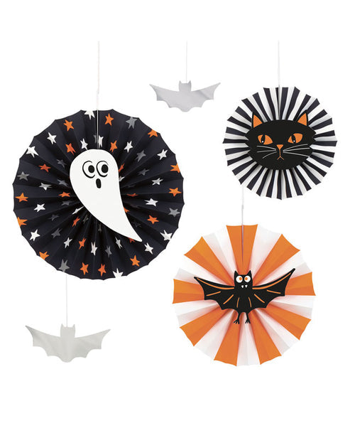 Black felt bats and white ghost cutouts strung on natural jute twine across a dark wooden fireplace mantel.
