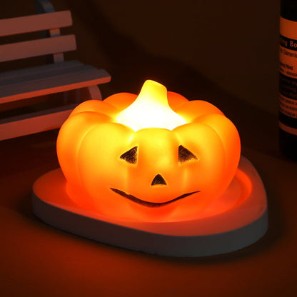 A soft silicone LED pumpkin nightlight glowing gently on a child's bedside table with a cozy orange light.