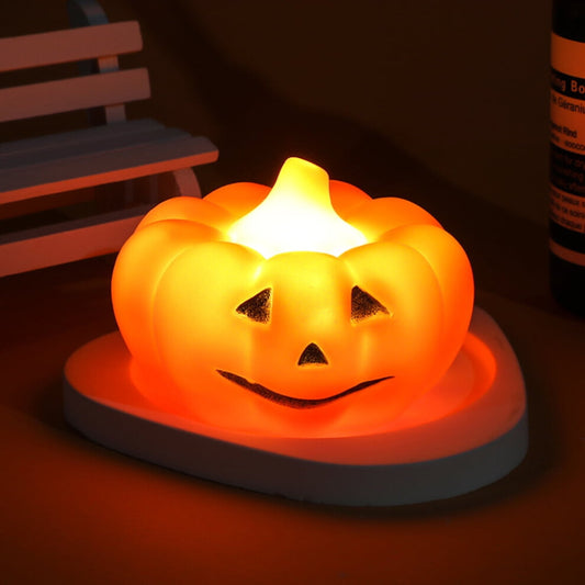 A soft silicone LED pumpkin nightlight glowing gently on a child's bedside table with a cozy orange light.