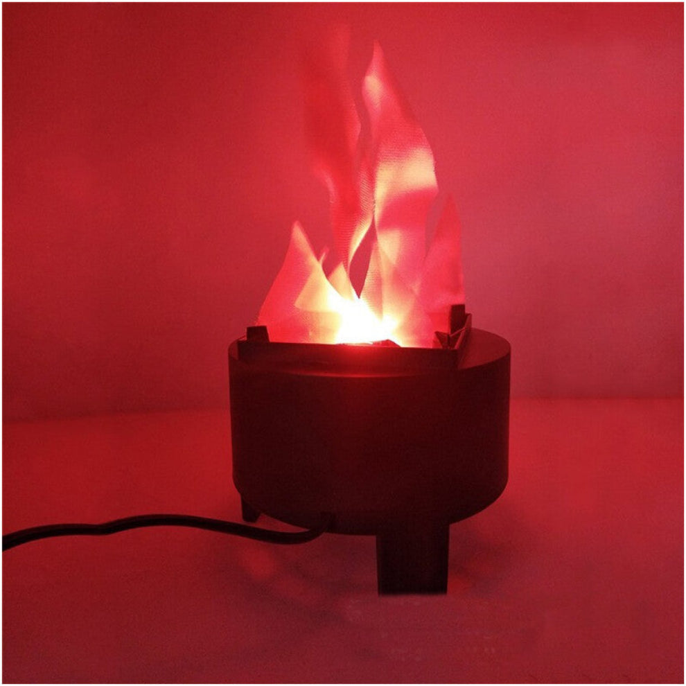 A Behogar simulated LED flame lamp glowing with a realistic flickering fire illusion on a dark Halloween party table.