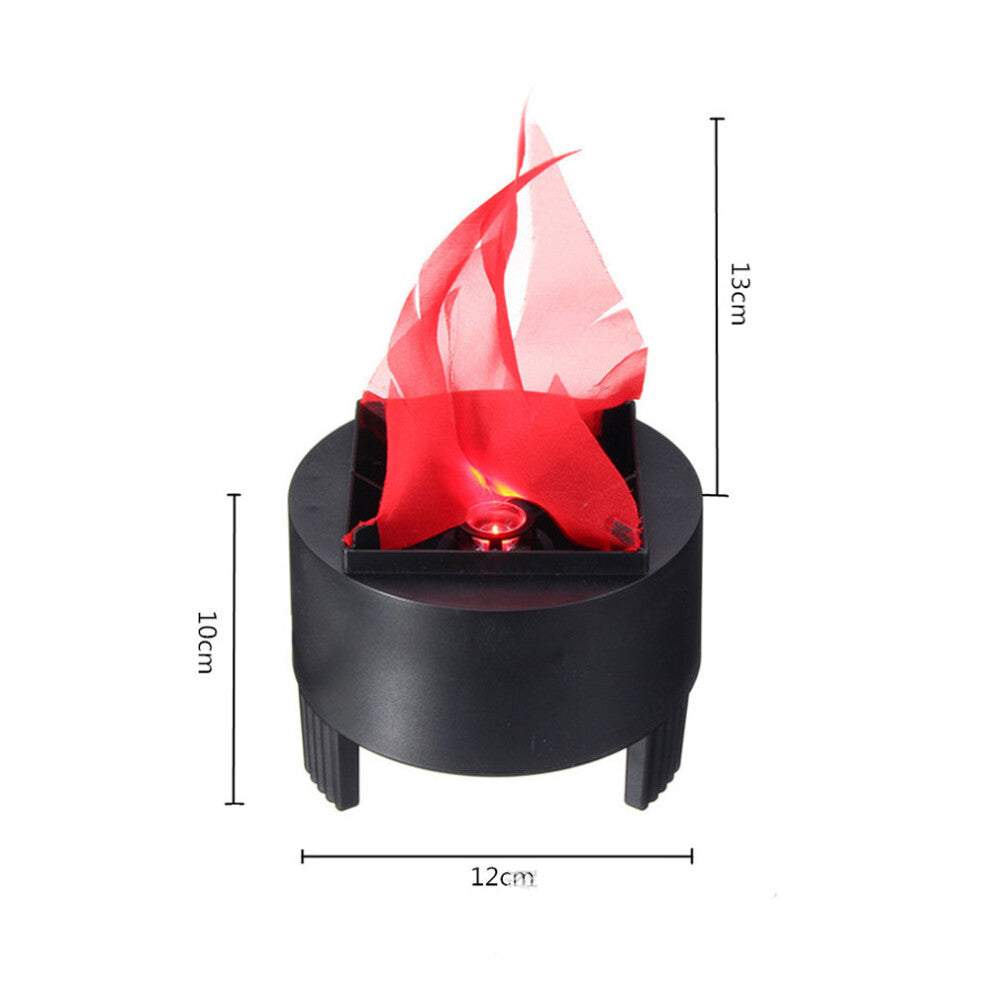 A Behogar simulated LED flame lamp glowing with a realistic flickering fire illusion on a dark Halloween party table.