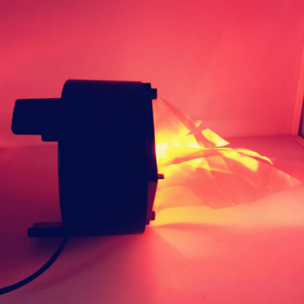 A Behogar simulated LED flame lamp glowing with a realistic flickering fire illusion on a dark Halloween party table.