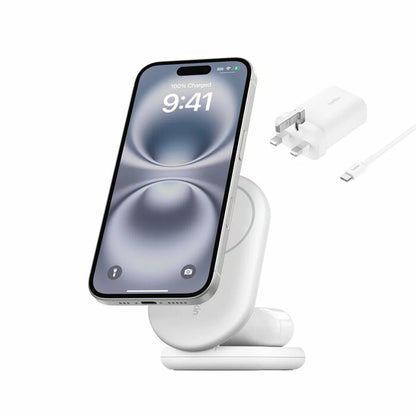 A side angle view of a sleek black Belkin 2-in-1 foldable charging stand holding a smartphone magnetically in landscape mode on a clean desk surface.