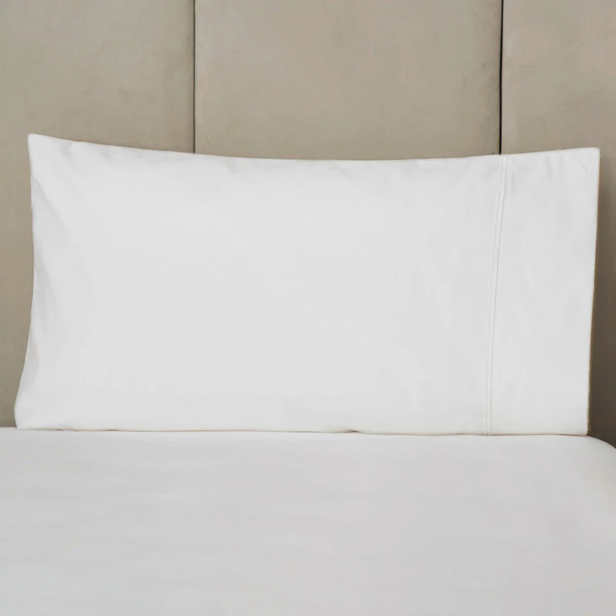 Side view of two crisp white Belledorm 1000 thread count Egyptian cotton king-size pillowcases with a smooth sateen sheen arranged neatly on a modern bed.