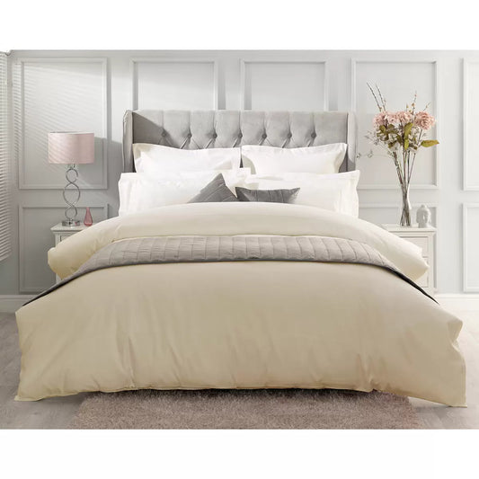 Ivory Belledorm 1000 thread count Egyptian cotton sateen duvet cover draped over a modern bed frame in a brightly lit bedroom.