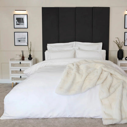 Belledorm 1200 thread count pure white sateen duvet cover styled elegantly on a luxury king size mattress