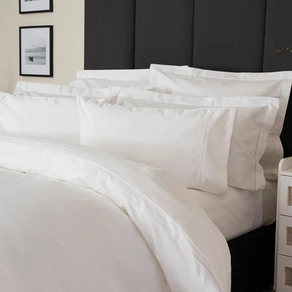 Belledorm 1200 thread count pure white sateen duvet cover styled elegantly on a luxury king size mattress