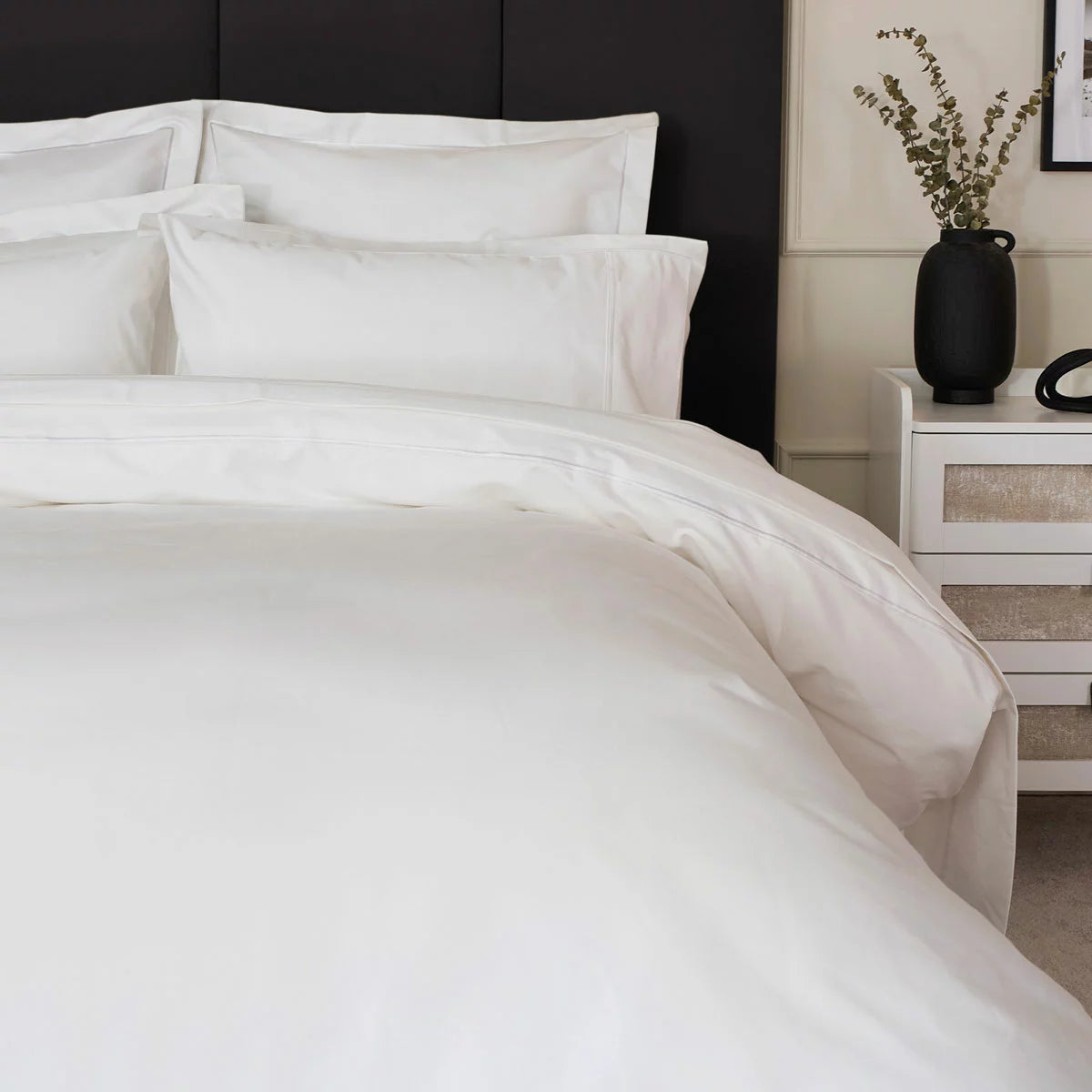 Belledorm 1200 thread count pure white sateen duvet cover styled elegantly on a luxury king size mattress