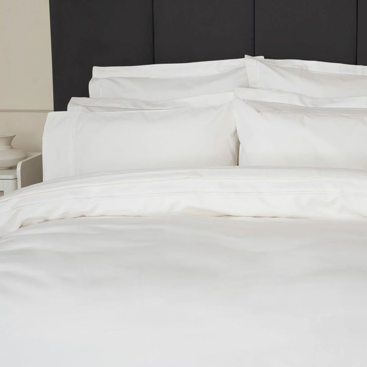 Belledorm 1200 thread count pure white sateen duvet cover styled elegantly on a luxury king size mattress