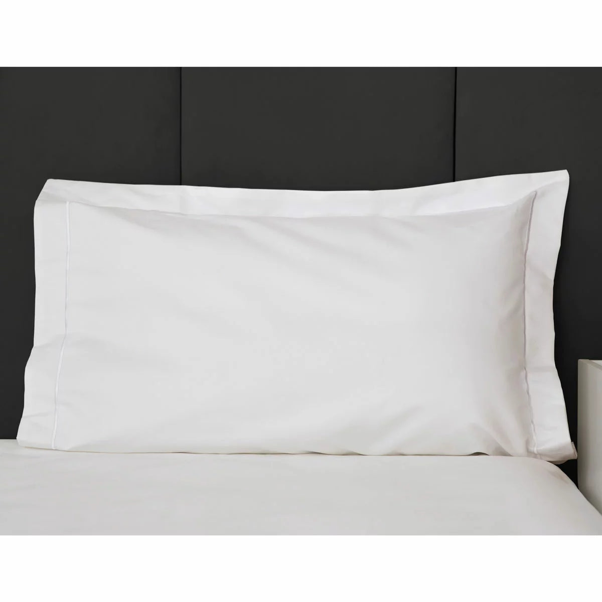 Belledorm 1200 thread count white Oxford pillowcase pair showcasing the elegant decorative border on a luxury mattress