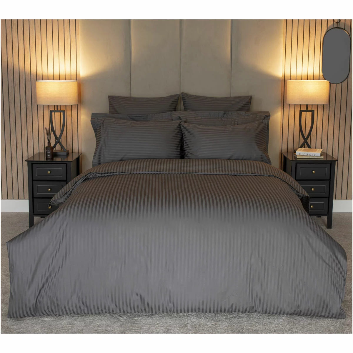 Flat lay of the Belledorm 540 thread count charcoal satin stripe double duvet cover set with matching pillowcases arranged neatly on a modern bed.