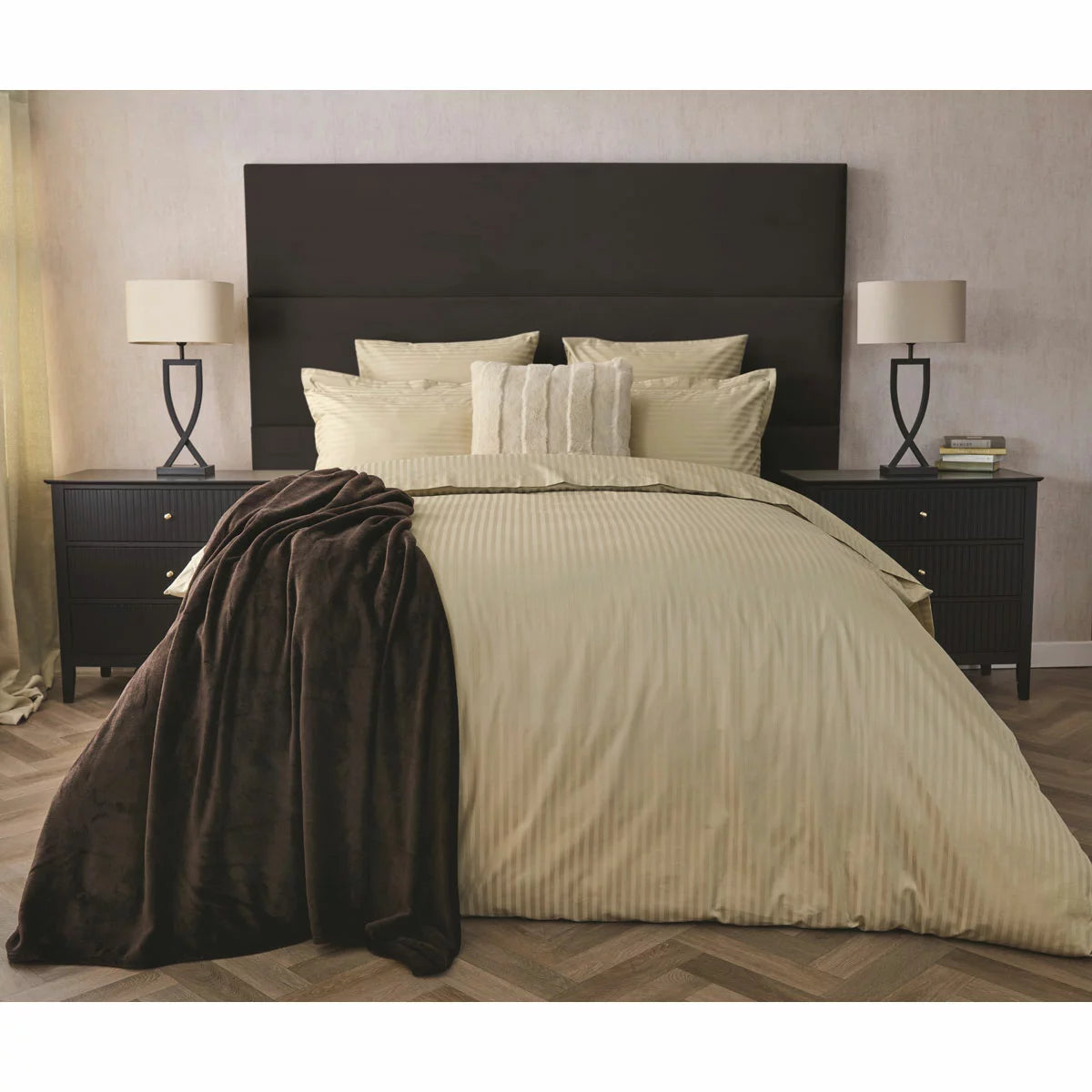 Flat lay image of the Belledorm 540 thread count taupe satin stripe duvet cover set with matching pillowcases neatly laid out on a neutral wooden bedframe.