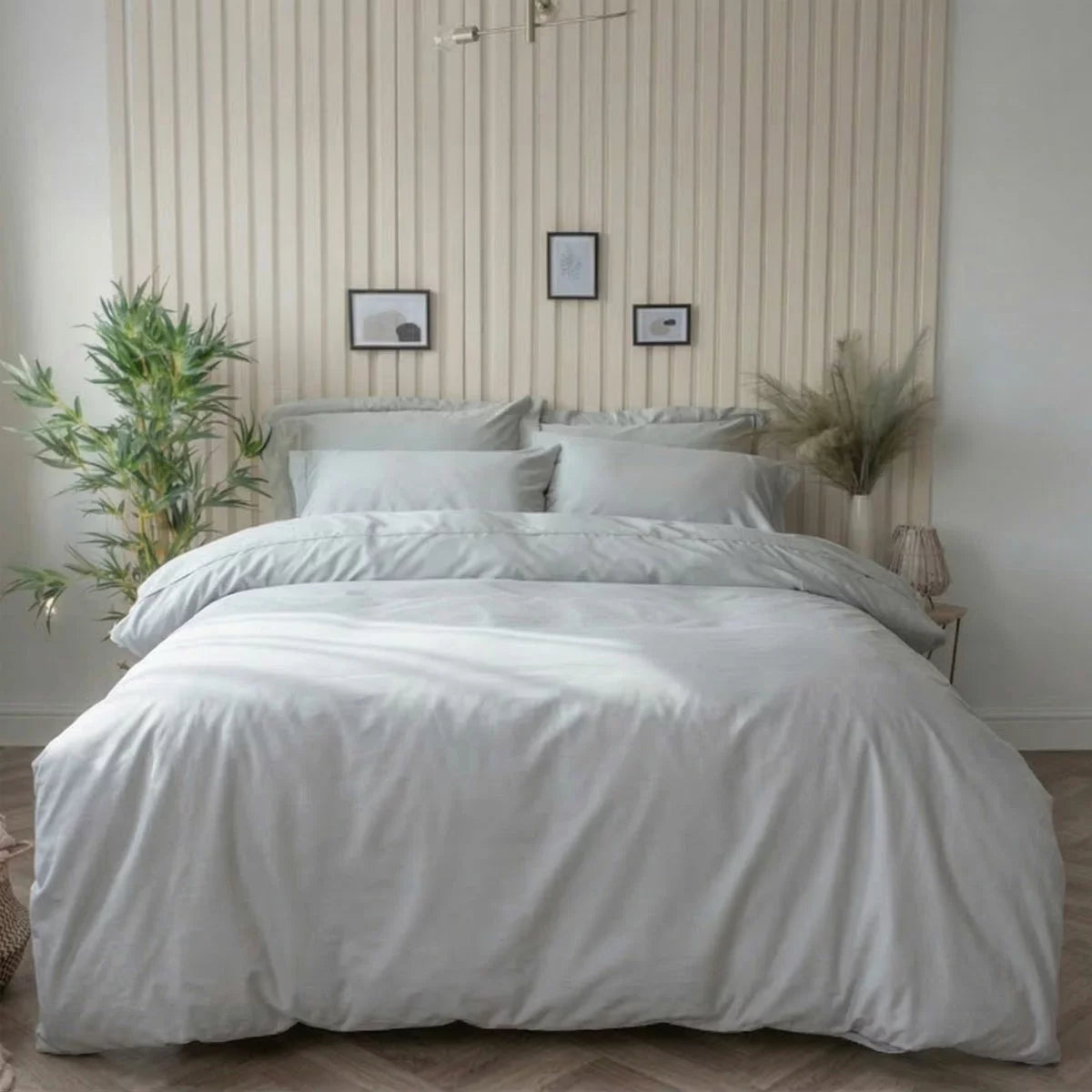 A studio shot of the platinum grey Belledorm bamboo cotton duvet cover set smoothly laid out on a bed, showcasing the silky finish of the fabric and the matching pillowcases.
