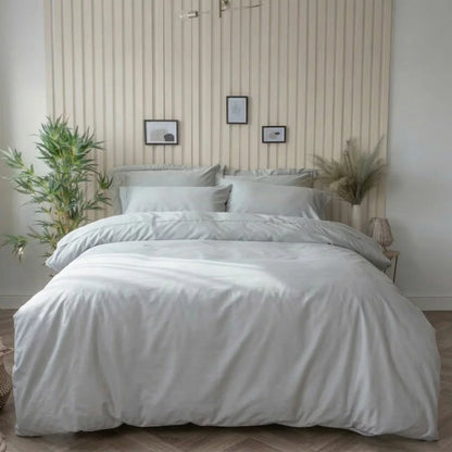 A studio shot of the platinum grey Belledorm bamboo cotton duvet cover set smoothly laid out on a bed, showcasing the silky finish of the fabric and the matching pillowcases.