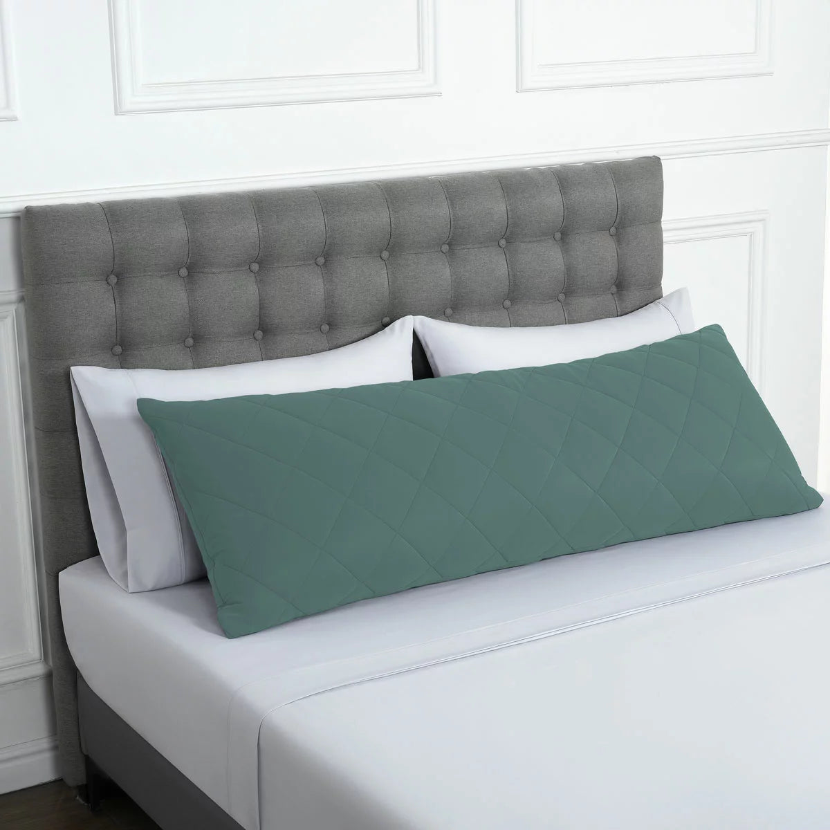 Below Zero cooling body pillow in a soft neutral tone with a textured circular-knit cover resting on a contemporary bed setting.