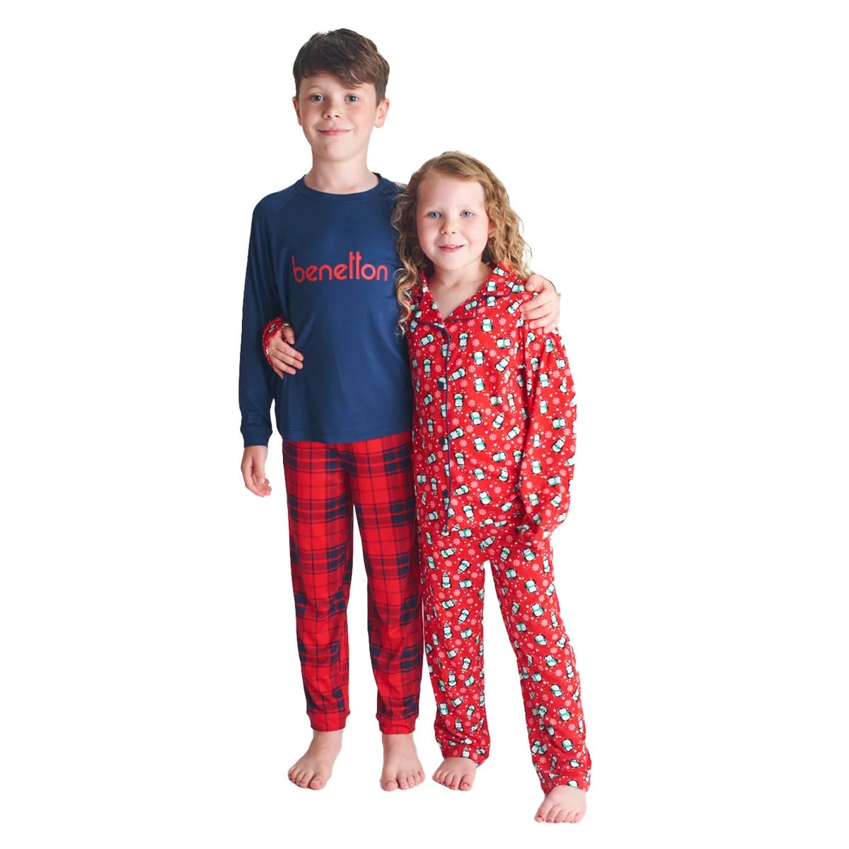 Flat lay view of the United Colours of Benetton Kids 4 Piece Pyjama Set showing vibrant blue, red, and navy printed long-sleeve tops and matching bottoms on a clean white background.