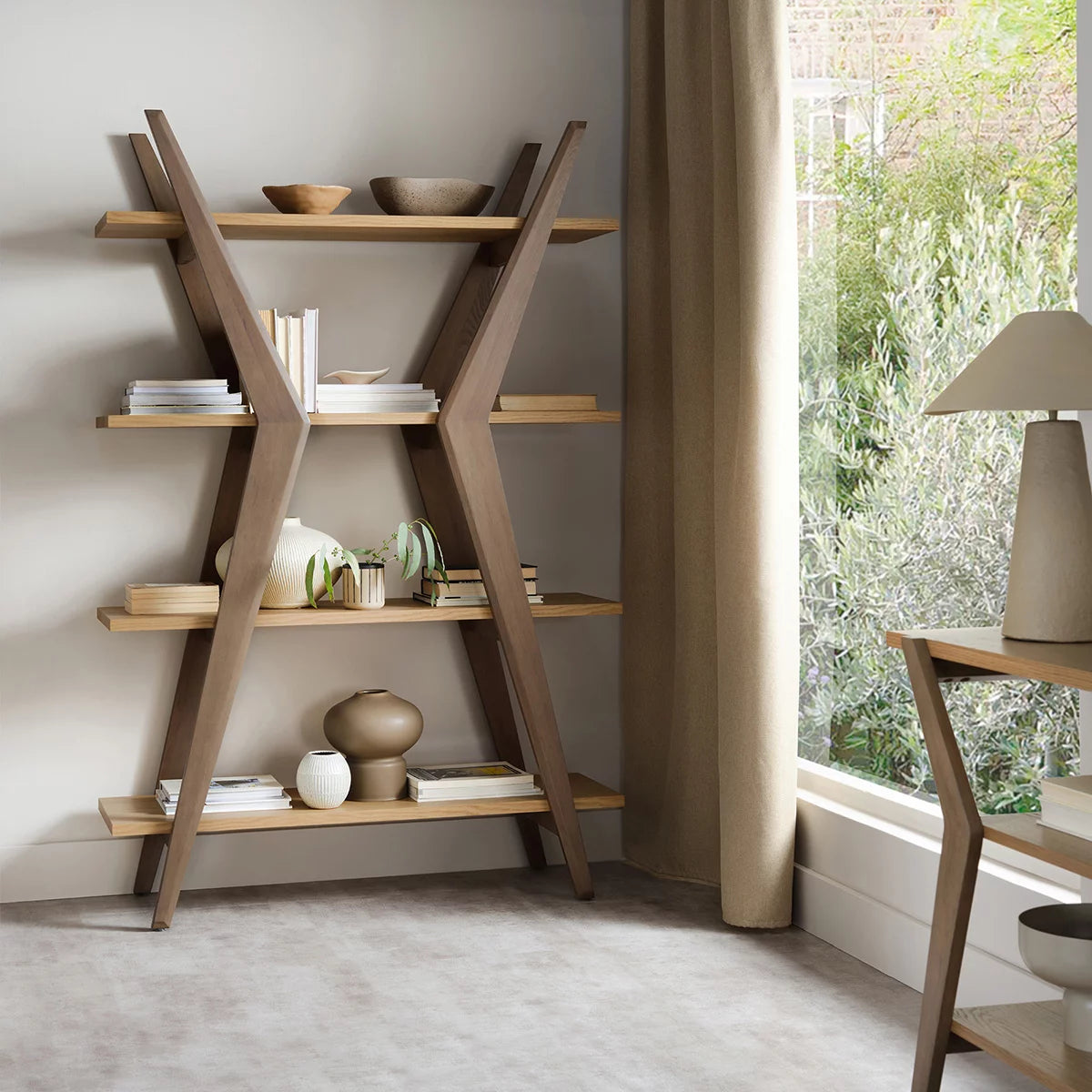 Front angle view of the Bentley Designs Kristen Light Oak Open Display Bookcase showing four open shelves and natural wood grain.