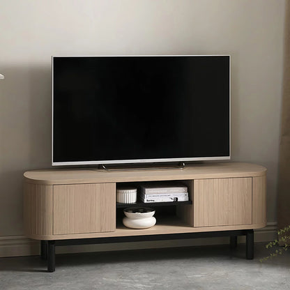Front angle view of the Bentley Designs Vega Scandi Light Oak TV Entertainment Unit featuring curved doors and a central shelf on a peppercorn base.