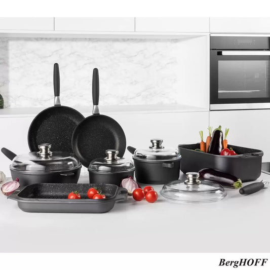 Complete 11-piece BergHOFF Eurocast non-stick cookware set including detachable handles, glass lids, and double roasting pan on a modern quartz kitchen island.