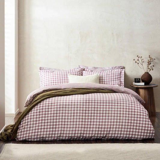 Flat lay of the single Yard Barton 100% cotton duvet cover set in berry gingham on a white wooden bed, showcasing the reversible mélange reverse pattern and neat Oxford border pillowcase.