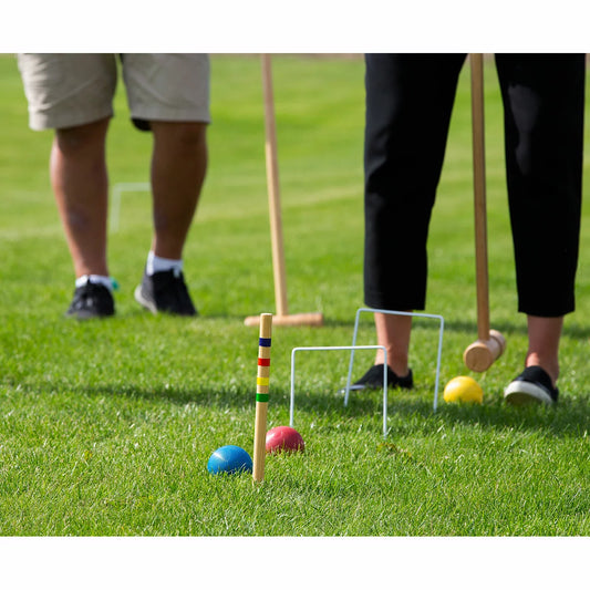 Bex Croquet Pro Set featuring six hardwood mallets and colorful balls neatly organized in a classic wooden storage box.