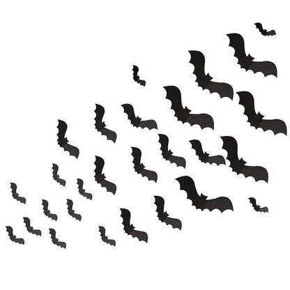 Matte black 3D paper bat cutouts in various sizes arranged on a white wall in a flying swarm pattern.
