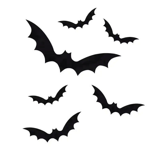 A set of nine black bat static cling window stickers arranged on a clear glass pane during a Halloween home setup.