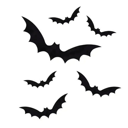 A set of nine black bat static cling window stickers arranged on a clear glass pane during a Halloween home setup.