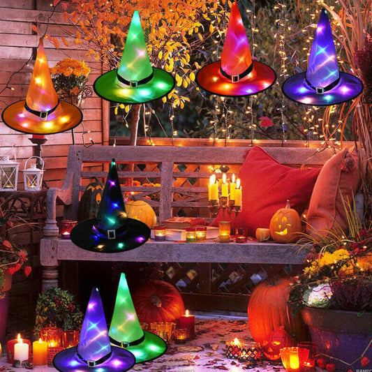 A black Halloween LED light-up witch hat glowing warmly while hanging against a dark background outdoors.
