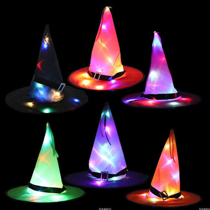 A black Halloween LED light-up witch hat glowing warmly while hanging against a dark background outdoors.