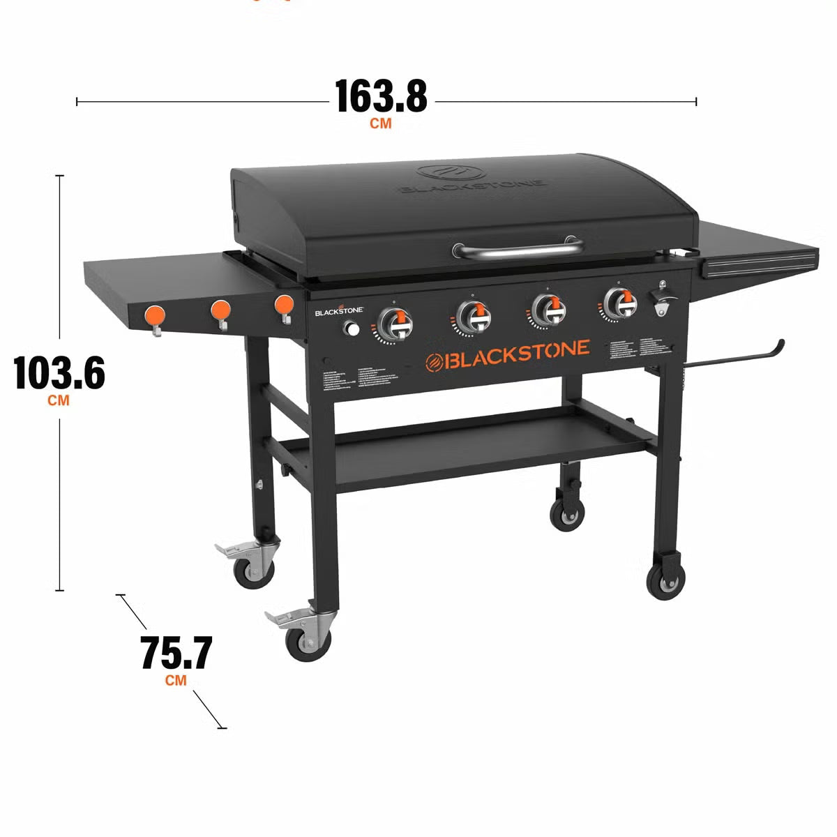 Angle view of the large black 4 burner Blackstone 36 inch gas griddle with hood raised, showing the massive steel cooktop, folded side shelves, and caster wheels on a patio.