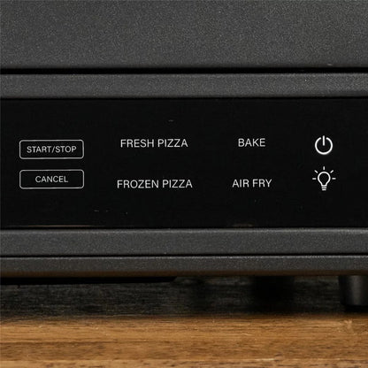 Front view of the black Blackstone E-Series electric pizza and air fryer oven sitting on a kitchen counter displaying its touchscreen control panel and open glass door with a 14 inch rotating deck inside.