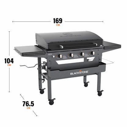 Blackstone Omnivore 36" Griddle with hood open, showing the spacious raw steel cooking surface and integrated front accessory shelves on a patio.