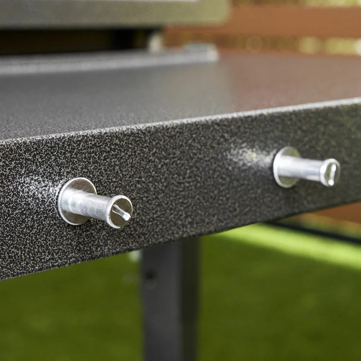 Blackstone Omnivore 36" Griddle with hood open, showing the spacious raw steel cooking surface and integrated front accessory shelves on a patio.