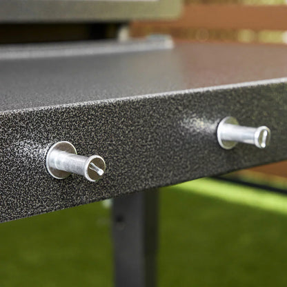 Blackstone Omnivore 36" Griddle with hood open, showing the spacious raw steel cooking surface and integrated front accessory shelves on a patio.