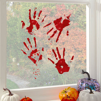 Realistic bloody handprint static cling stickers displayed on a clear glass window during a Halloween setup.
